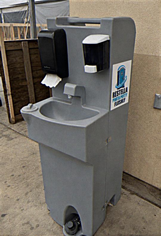 Free-standing portable hand washing station with soap and paper towel dispensers
